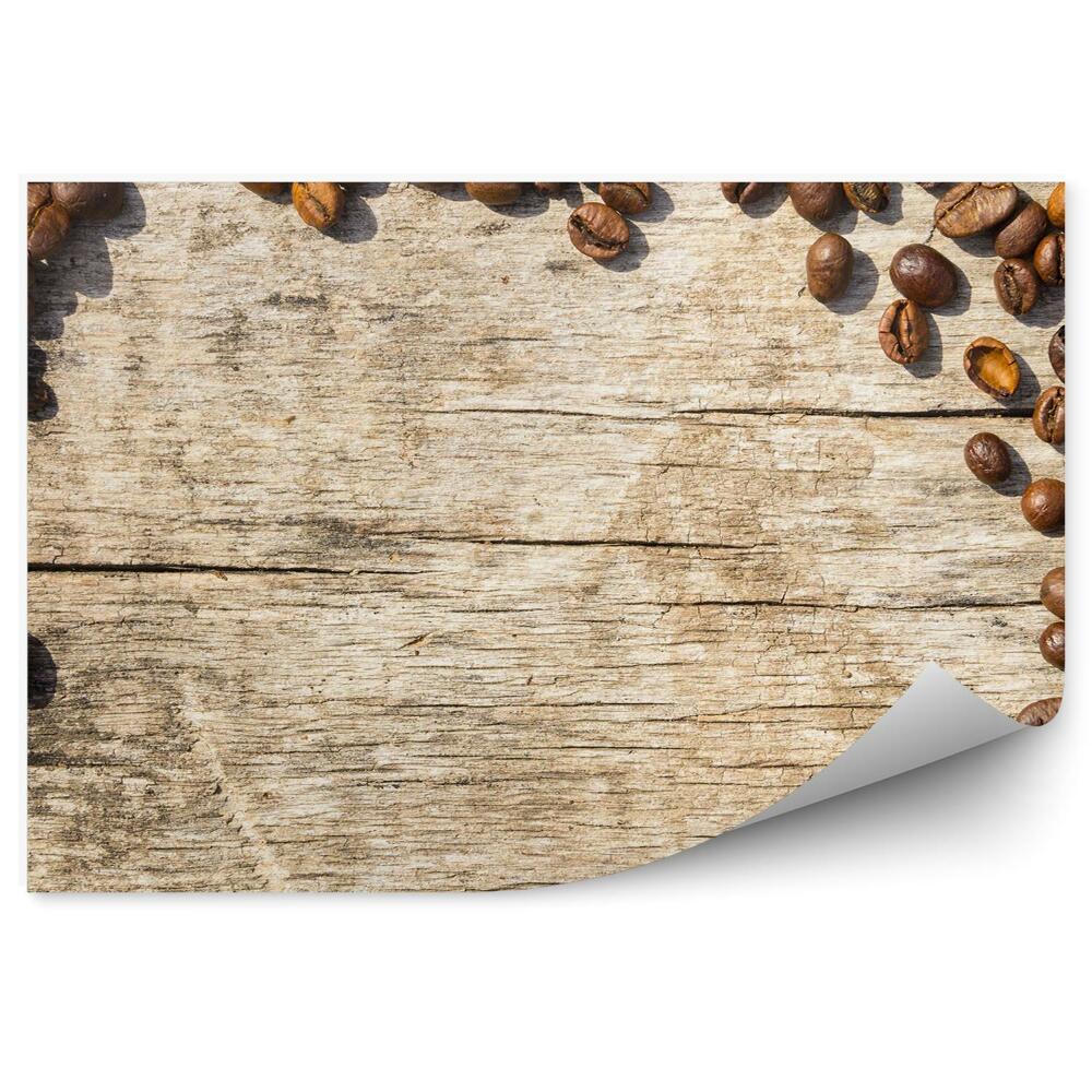 Fototapeta Rozsypane ziarenka kawy drewniane tło ramka