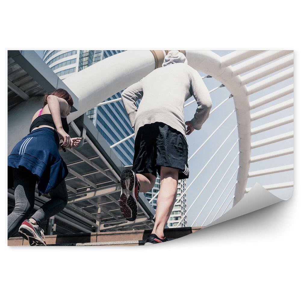 Fototapeta samoprzylepna Bieganie po schodach sport fitness wieżowce ludzie