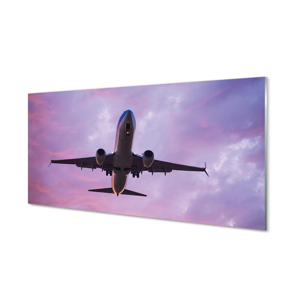 Obraz na szkle Samolot na tle fioletowych chmur