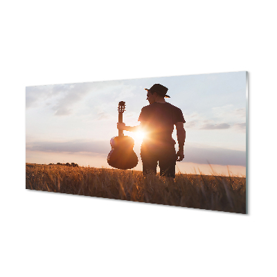Obraz na szkle Człowiek na łące z gitarą